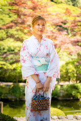 Portrait of a young woman wearing yukata summer kimono with soft blur background in a Japanese...
