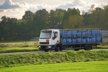 A Truck Delivering LPG Cylinders for Home Use on the Road. A Fuel and Energy Industry that Provides...