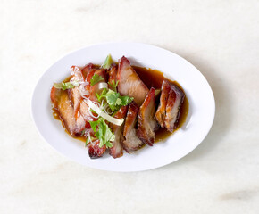 traditional local style Char Siu or Char Siew - Honey barbecue roast pork on white plate of marble table - Chinese style grilled pork.