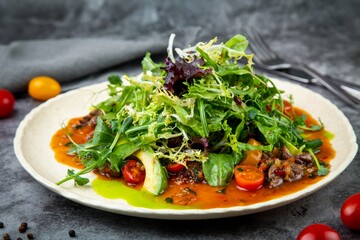 warm Asian salad with horse meat and herbs side view