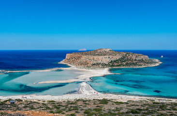 Fototapeta premium Blue lagoon in Balos, Crete, Greece. Beautiful lagoon at Mediterranean Sea. Balos Bay capture on the top of the mountain. View from above on a Gramvousa Island.