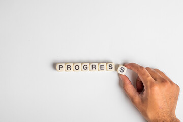 Progress Word dice human hand completing word progress , isolated on white background