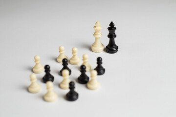 black and white chess pieces on white background, racism concept