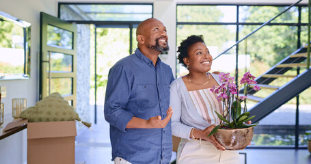 Couple, flowers and happy in new home or real estate with property investment, fresh start and...