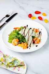 shrimp with avocado slices and arugula with teriyaki sauce side view