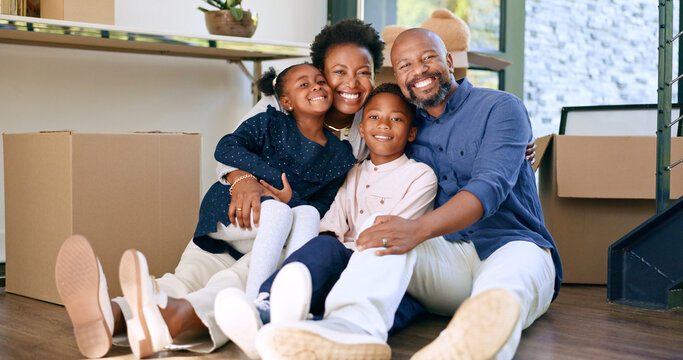 Moving, portrait and happy black family in home with boxes and hug in living room together. New house, property and smile for investment in real estate, growth and parents embrace children on floor