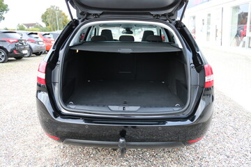 Opened clean modern empty car trunk.