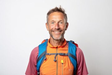 Portrait of a grinning man in his 50s sporting a technical climbing shirt against a white background. AI Generation