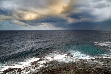 Dramatic sky, sea, strong wind, reefs