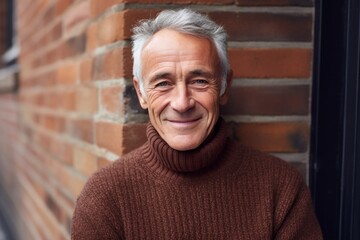 Portrait of a blissful man in his 70s wearing a cozy sweater against a vintage brick wall. AI Generation