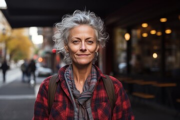 Portrait of a merry woman in her 50s wearing a comfy flannel shirt against a bustling city cafe. AI...