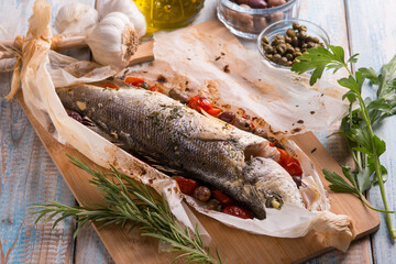 sea bass in foil with black olives tomatoes adn capers