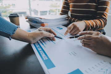 Financial analysts analyze business financial reports on a digital tablet planning investment project during a discussion at a meeting of corporate showing the results of their successful teamwork.