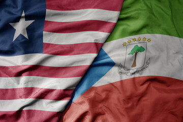 Obraz premium big waving national colorful flag of equatorial guinea and national flag of liberia .