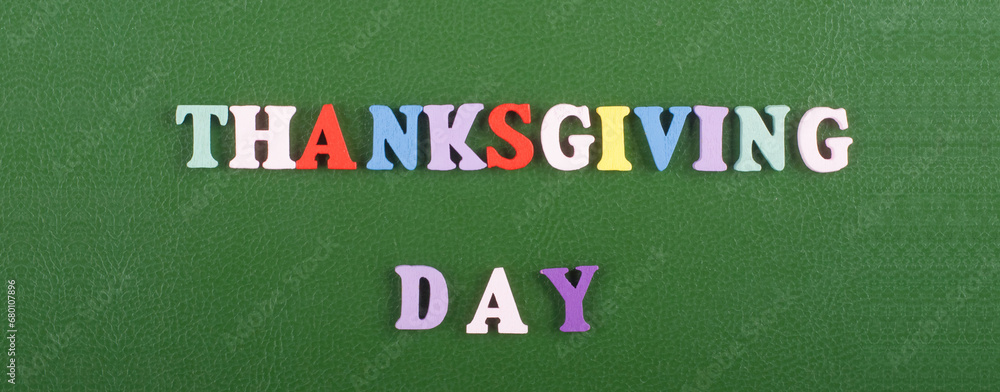 Fototapete thanksgiving day word on green background composed from colorful abc alphabet block wooden letters, 