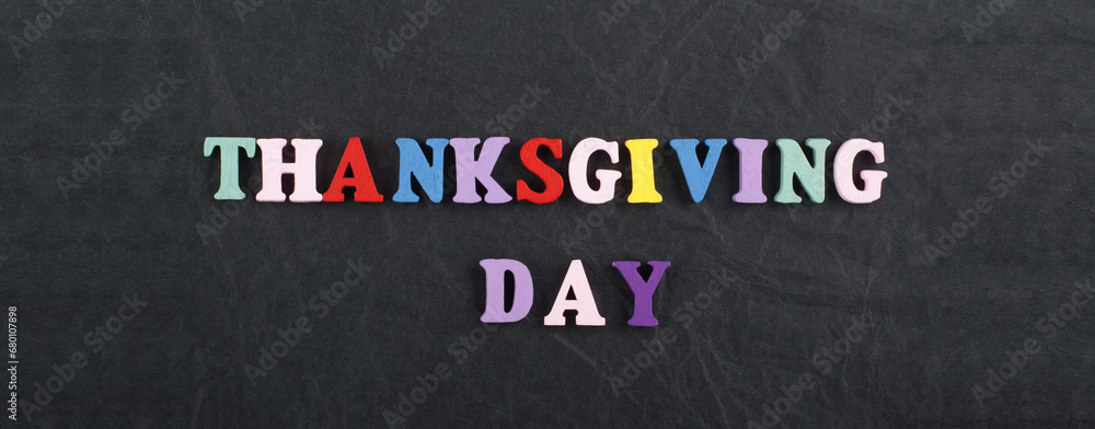 Fototapete thanksgiving day word on black board background composed from colorful abc alphabet block wooden let