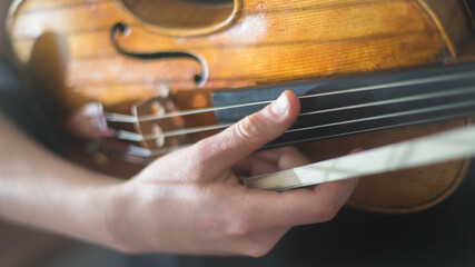 close up of a person playing a violin