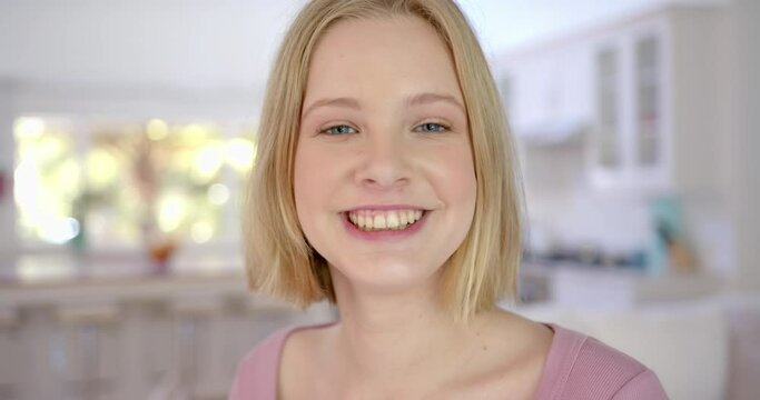 Portrait of happy caucasian female teenager with blond hair at home, slow motion