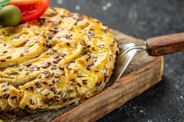 Snail pie borek with meat on a wooden board, Restaurant menu, dieting, cookbook recipe top view