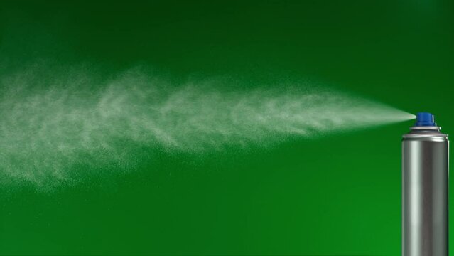 spray can on green background sprays fountain of vaporized foam particles. stabilized locked shot.