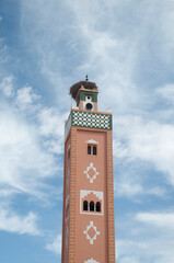 New colorful ornamental Moroccan minaret with stork nest