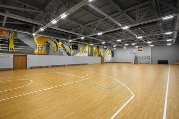 Interior of a large school gym hall. Multipurpose sport hall. School sport hall inside. No people.
