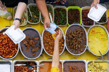 Paying for food at Kota Kinabalu Street Market