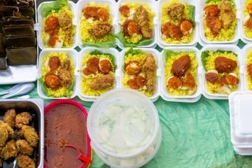 Top view shot of Nasi Kuning in a take away polystyrene container