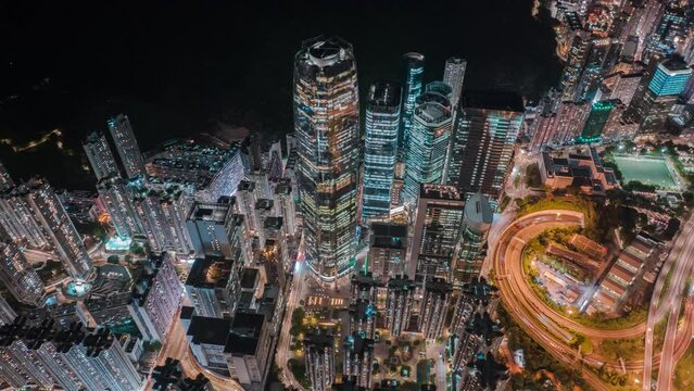 Top View Hyperlapse of Office and Business Districts in Hong Kong City Aerial view city streets at night, Establishing shot for Innovation technology and transportation Concept