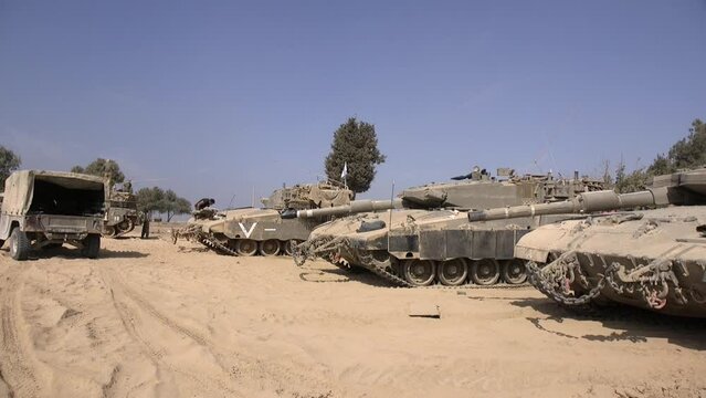 Tank forces, are being prepared, waiting for action on the desert soil. a supply vehicle is parked nearby. Be'eri, Israel.