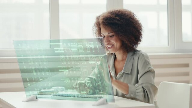 Smiling woman programmer successfully finishes creation of a new program