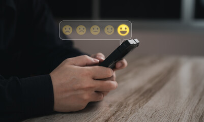 Business man use his finger to touching or pressing the virtual screen the smiley happy face with star to show satisfaction or the service or give rate. Concept of satisfaction and customer service.	