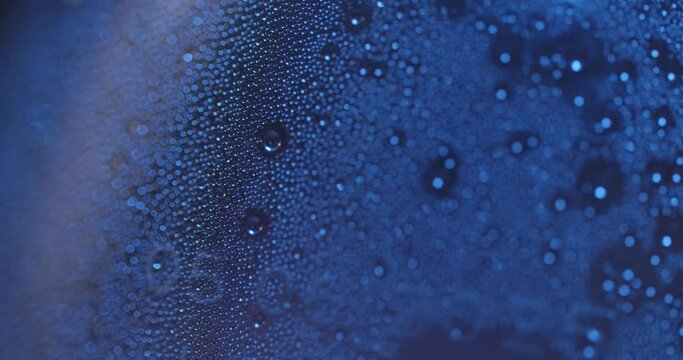 Beads of condensation on a glass surface - macro tetxure