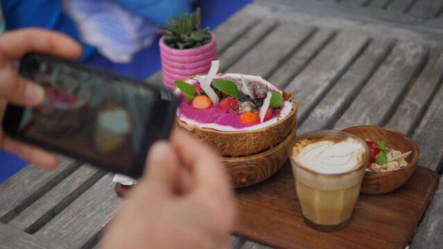 Dynamic video of blogger captures food: smoothie bowl, cappuccino, dessert Cinematic shot: visual feast of delectable delights this food blogger shares in social media Concept work as food blogger