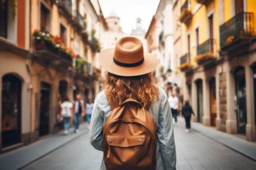 Keuken spatwand met foto Young Solo Girl Traveler Exploring the Streets of Old Town in Spain. Backpacker Tourist Enjoying a Vacation in a Charming European City. © Asiri