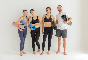 Fototapeta na wymiar Diverse Yoga Enthusiasts with Mats Ready for a Group Class