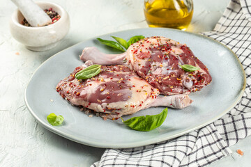 Fresh raw duck thigh on a light background top view. copy space