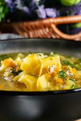 Cucumber soup in dark bowl.