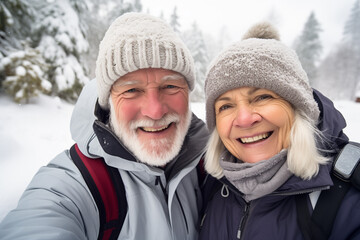 Fototapeta na wymiar Elderly couple embracing the joy of an active winter getaway in a picturesque snowy landscape, National Grandparents Day, International Day of Older Persons