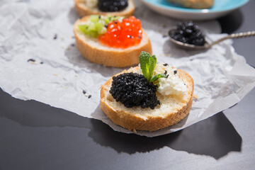 Party snacks of red and black caviar appetizer on the crumpled paper