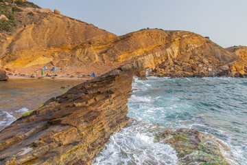 Fototapeta na wymiar Deserted Haven: Ain Kanassira's Beach Nestled Between Sea and Mountains in Tunisia