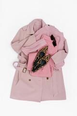Classic pale pink trench coat with jeans and leopard print shoes. Fashion spring or autumn outfit. Women's stylish and elegant clothes with accessory.  Flat lay, top view, overhead.