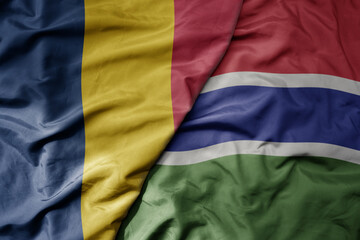big waving national colorful flag of gambia and national flag of chad .