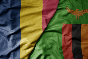 big waving national colorful flag of zambia and national flag of chad .