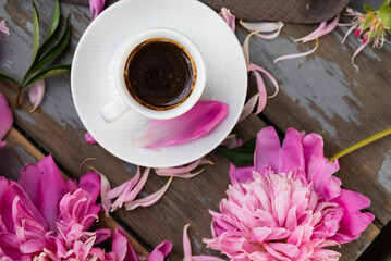 Pink peony flowers and a cup of coffee on a white background. Morninig, spring, fashion composition. Flat lay, top view, copy space.