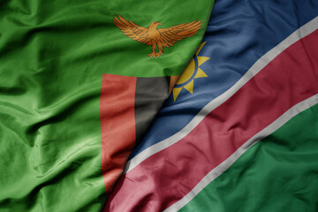 big waving national colorful flag of namibia and national flag of zambia .