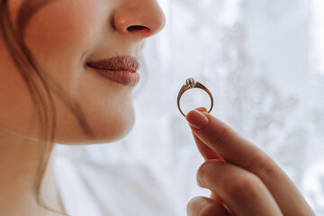 gold wedding ring in the bride's hand close-up. Precious jewelry concept. Wedding preparation. He...