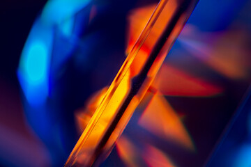 Light leak overlay coloured in orange and blue hues. Background is blurred.