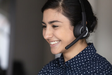 Happy Indian student girl, call center office worker, client support employee wearing headphones...