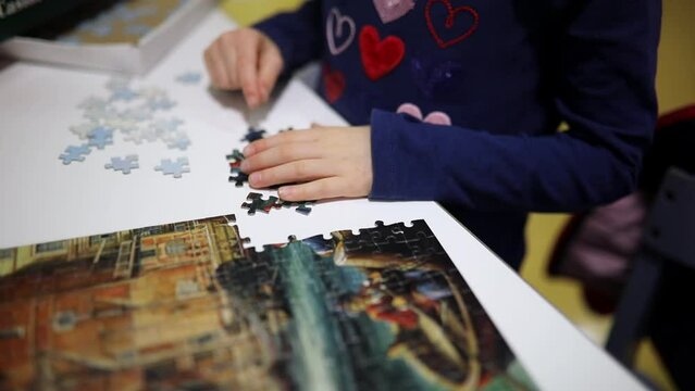 Adorable preschooler girl playing puzzles